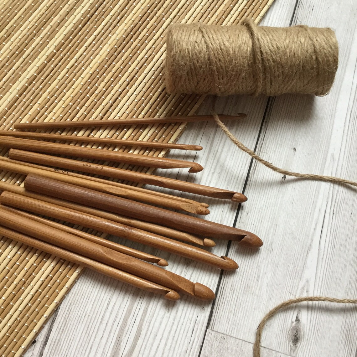 wooden hooks and a spool of twine on wood